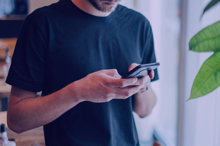 man typing on smartphone
