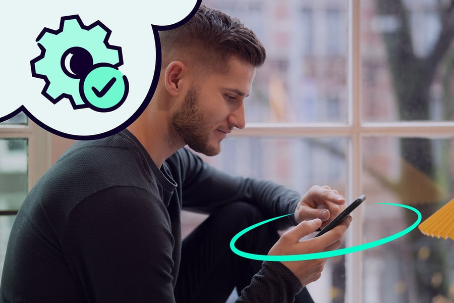 Man in casual clothing using his mobile phone with secured API.